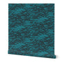 A roll of peel-and-stick wallpaper featuring a dark blue on teal abstract coastal wave pattern.
