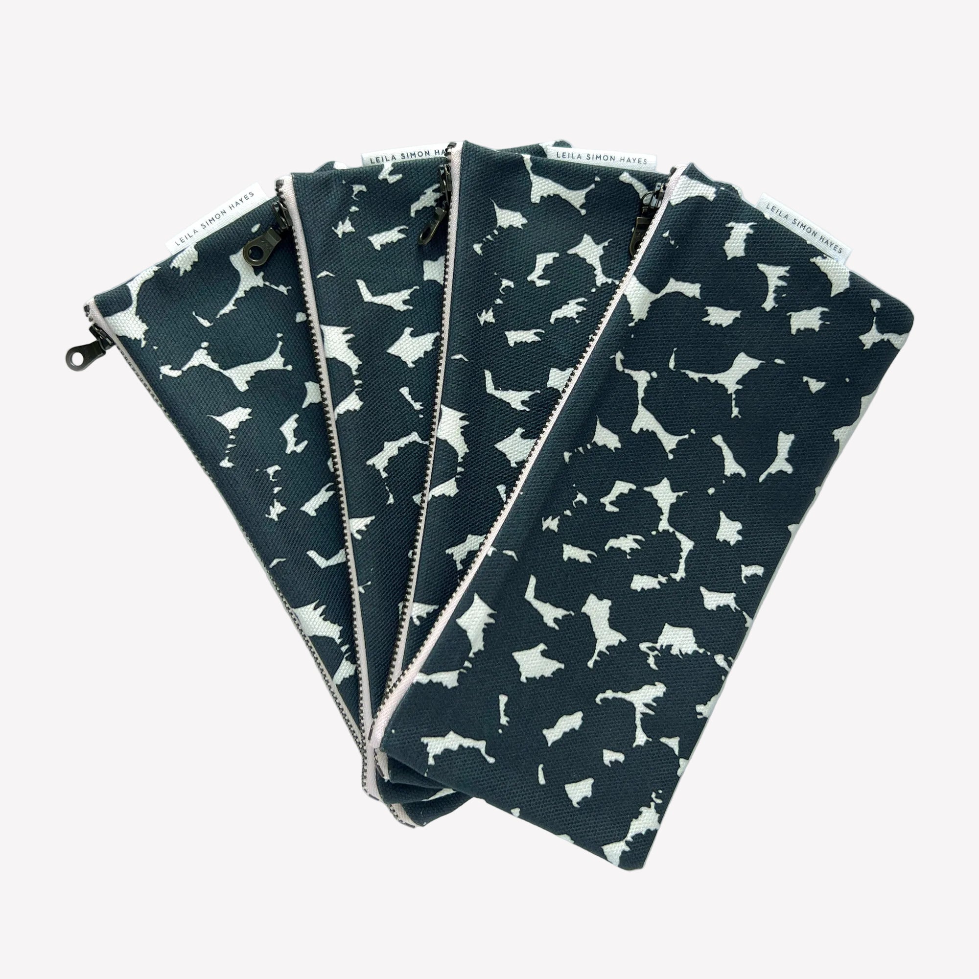Four black and white pouches with abstract dot pattern on a white background