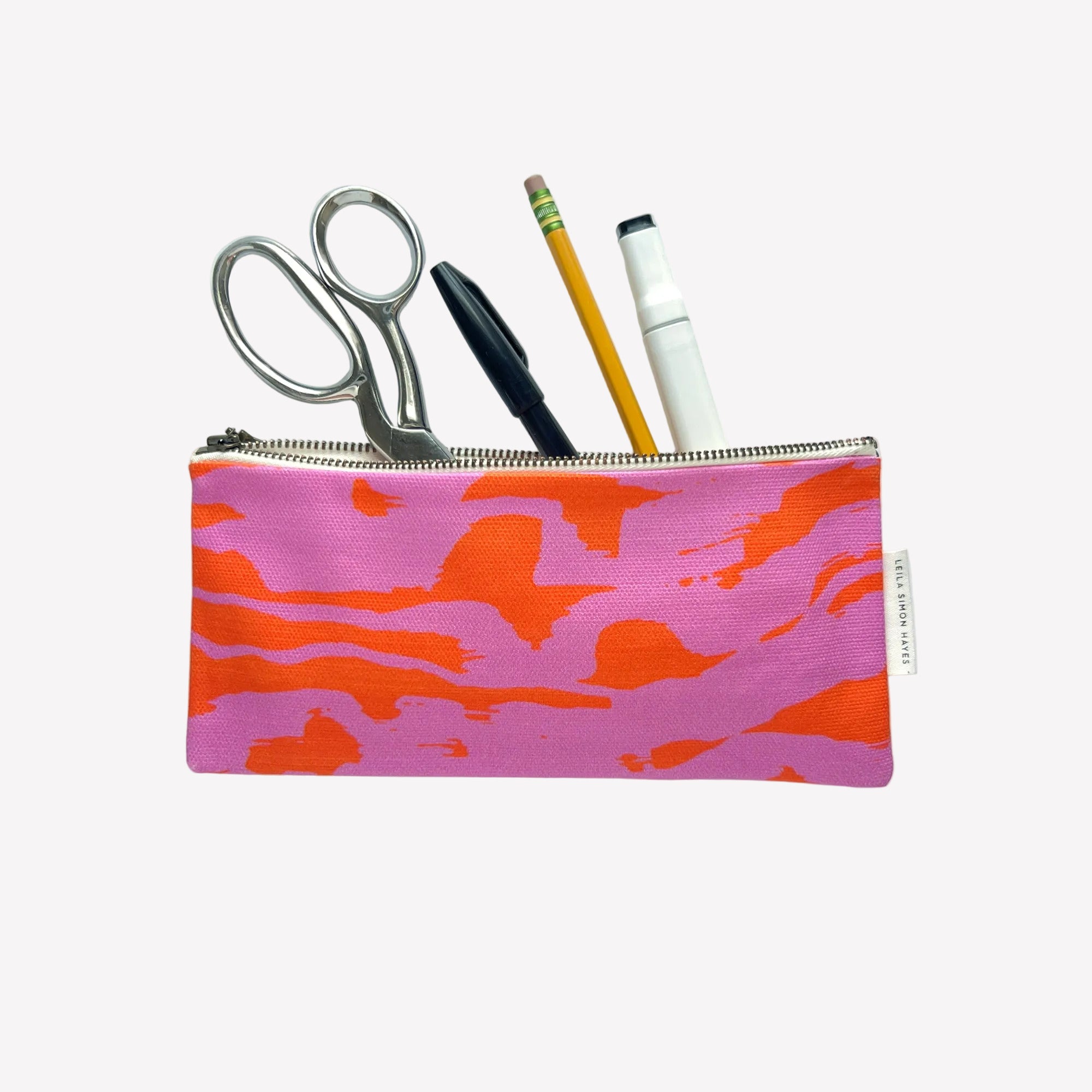Pink and orange wavy design pencil case with stationery items on a white background