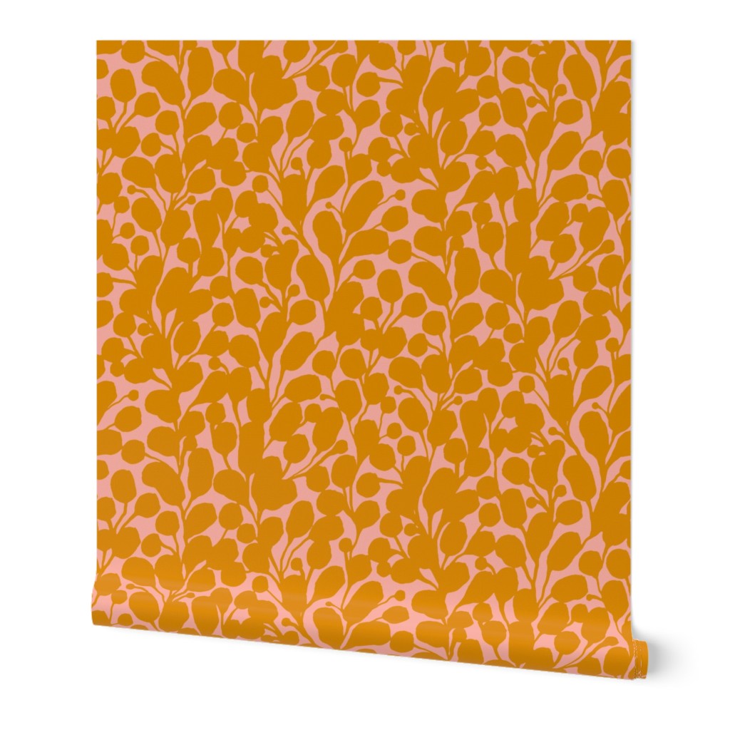 A roll of wallpaper featuring a hand-painted botanical leaf pattern with orange and pink hues. Designed by artist Leila Simon Hayes.