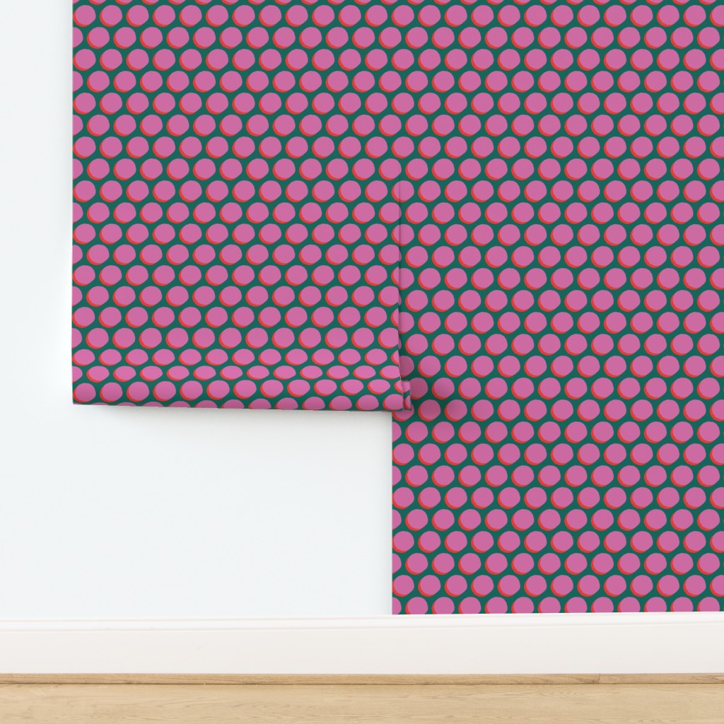 Roll of pink and green polka dot wallpaper on a white background. Designed by artist Leila Simon Hayes.