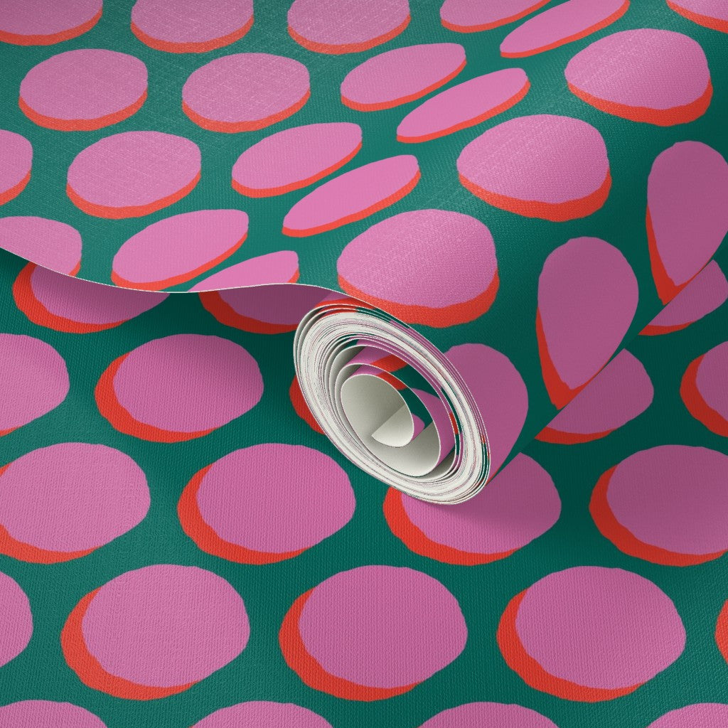 Roll of pink and red polka dot patterned wallpaper on a green background. Designed by artist Leila Simon Hayes.