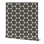 A roll of peel-and-stick black and white wallpaper featuring a hand-painted floral design with yellow accents. Designed by artist Leila Simon Hayes.