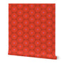 Roll of wallpaper with red patterned floral circular designs and a pink center, on a dark red base. Designed by artist Leila Simon Hayes.