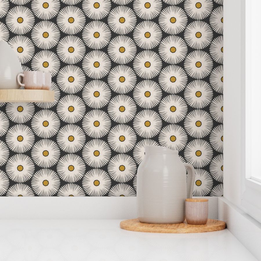 A section of wallpaper with a white background and black and white floral pattern, displayed as a kitchen backsplash  with decorative items on top. Designed by artist Leila Simon Hayes.