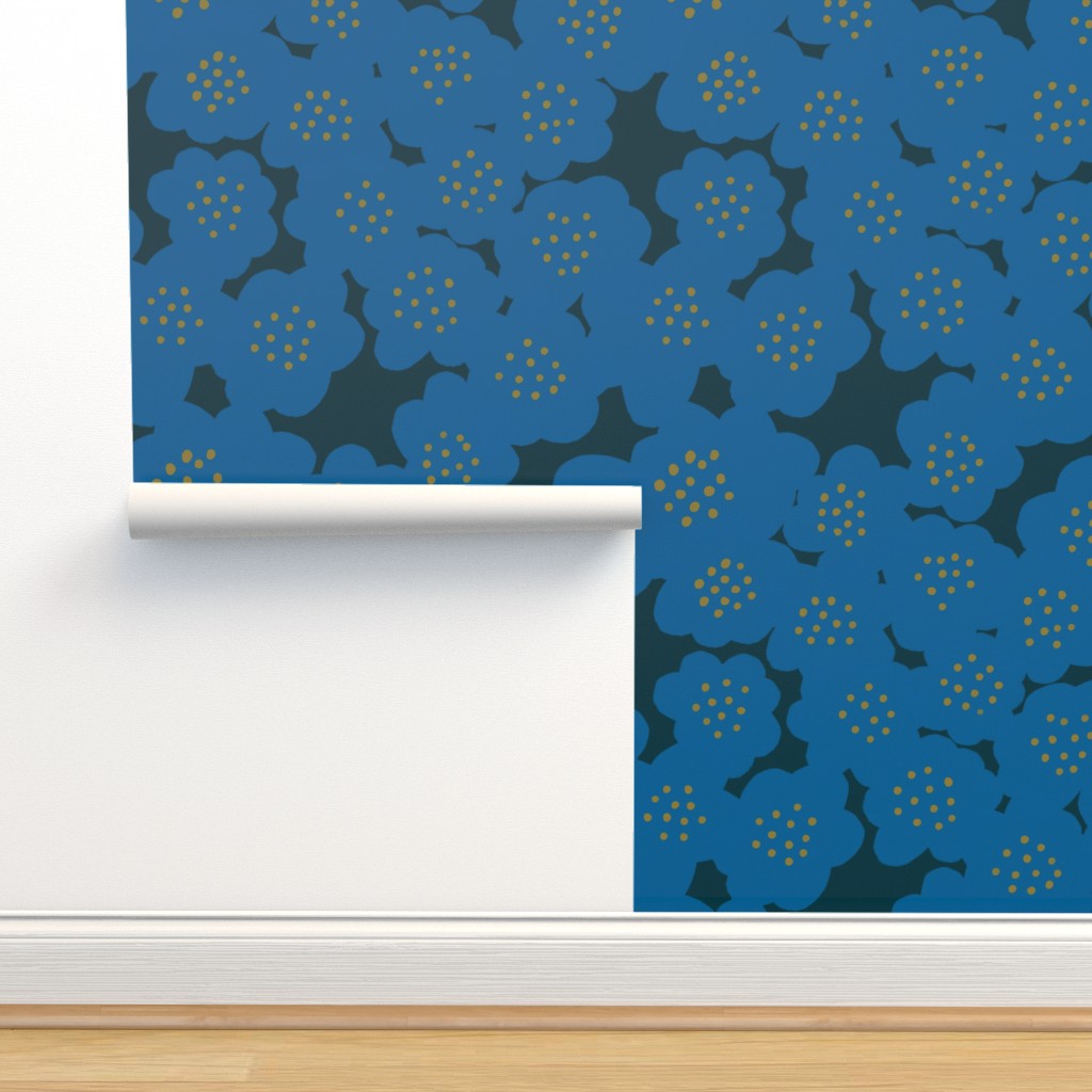 A roll of wallpaper with a floral design in blue. Designed by artist Leila Simon Hayes.