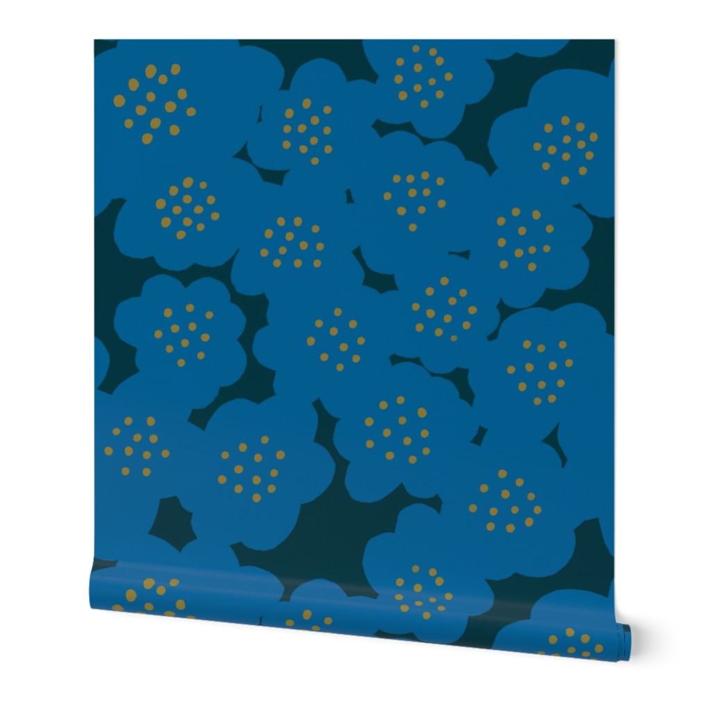 A roll of blue wallpaper with a hand-painted abstract floral design including larger blue flowers with yellow dotted centers, slightly overlapping. Designed by artist Leila Simon Hayes.