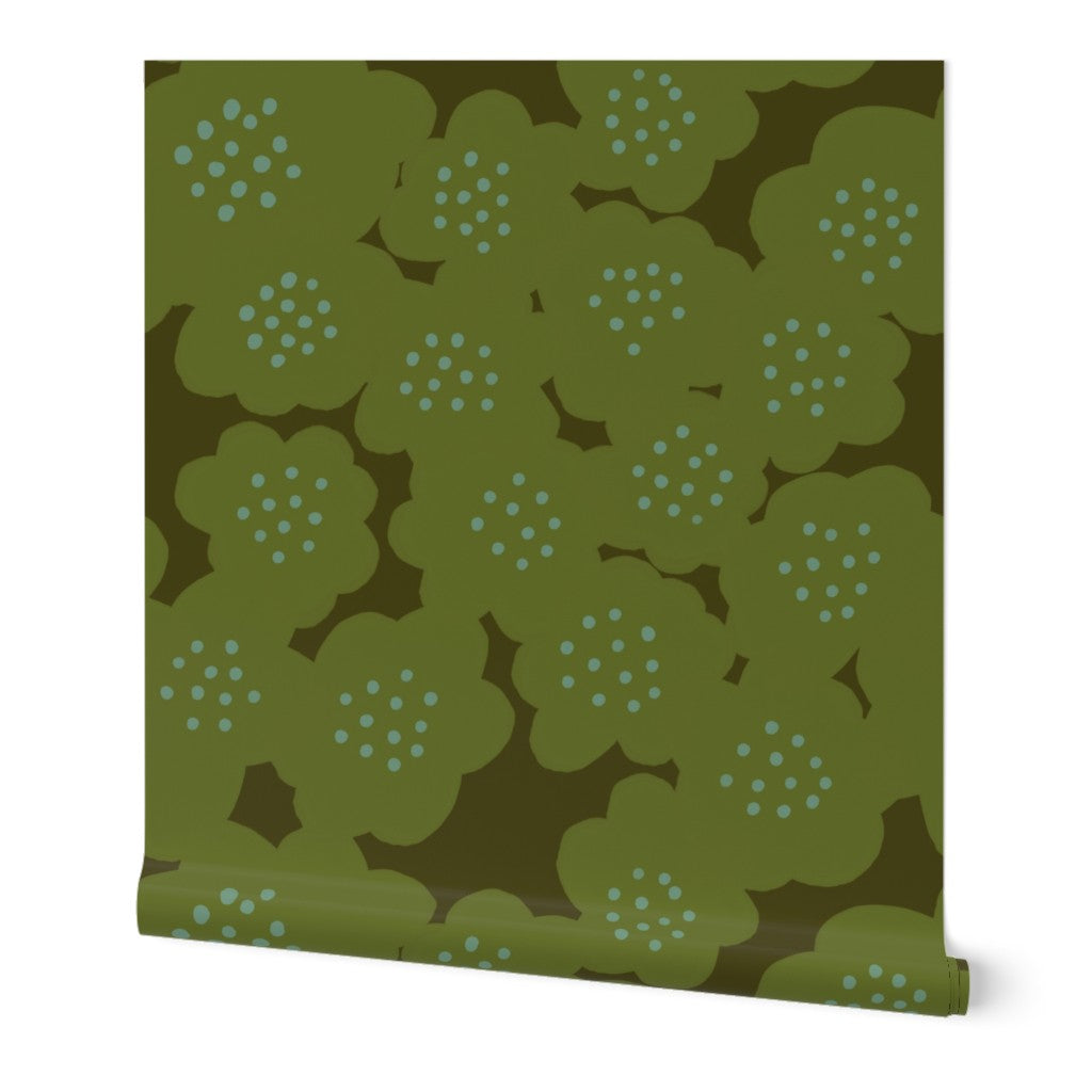 A roll of green wallpaper with a hand-painted abstract floral design including larger olive green flowers with blue dotted centers, slightly overlapping. Designed by artist Leila Simon Hayes.