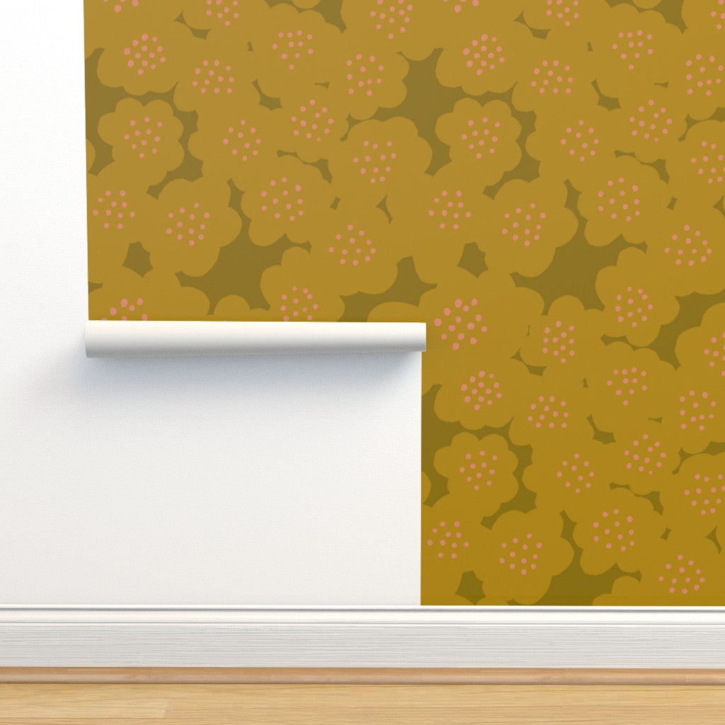 Roll of yellow floral wallpaper on a wall. Designed by artist Leila Simon Hayes.