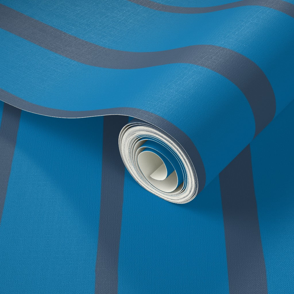 Roll of blue wallpaper with a white core on a blue background. Designed by artist Leila Simon Hayes.