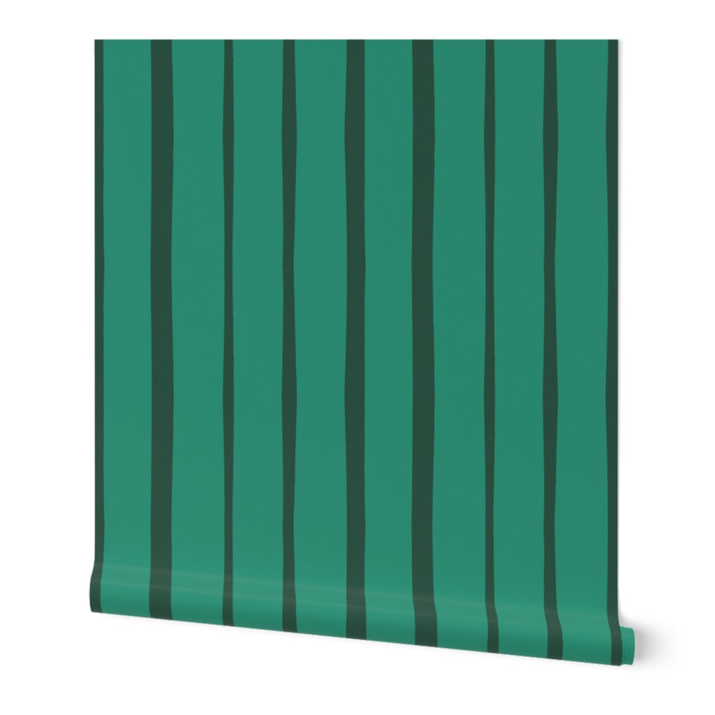 Roll of bright green and dark green wallpaper with vertical stripes. Designed by artist Leila Simon Hayes.