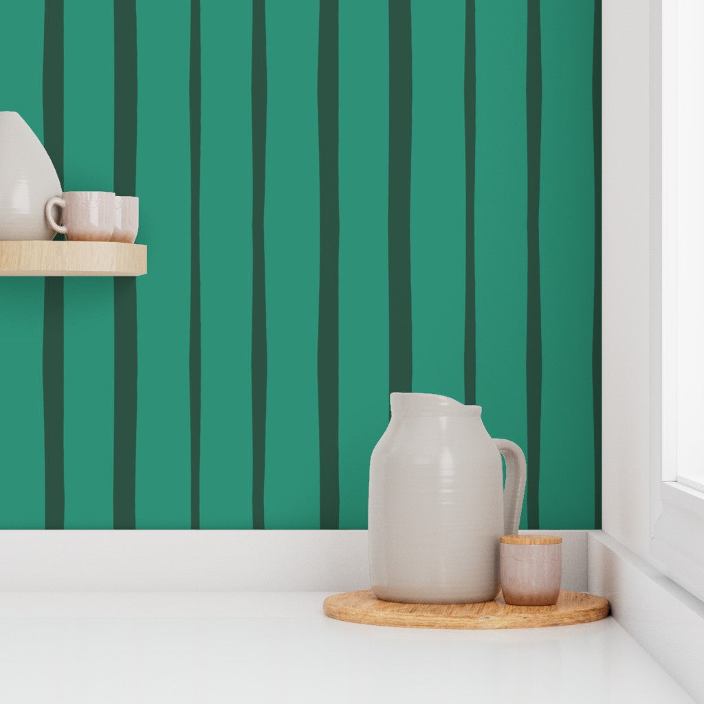 White ceramic pitcher and small cup on a wooden tray against a green striped wall. Designed by artist Leila Simon Hayes.