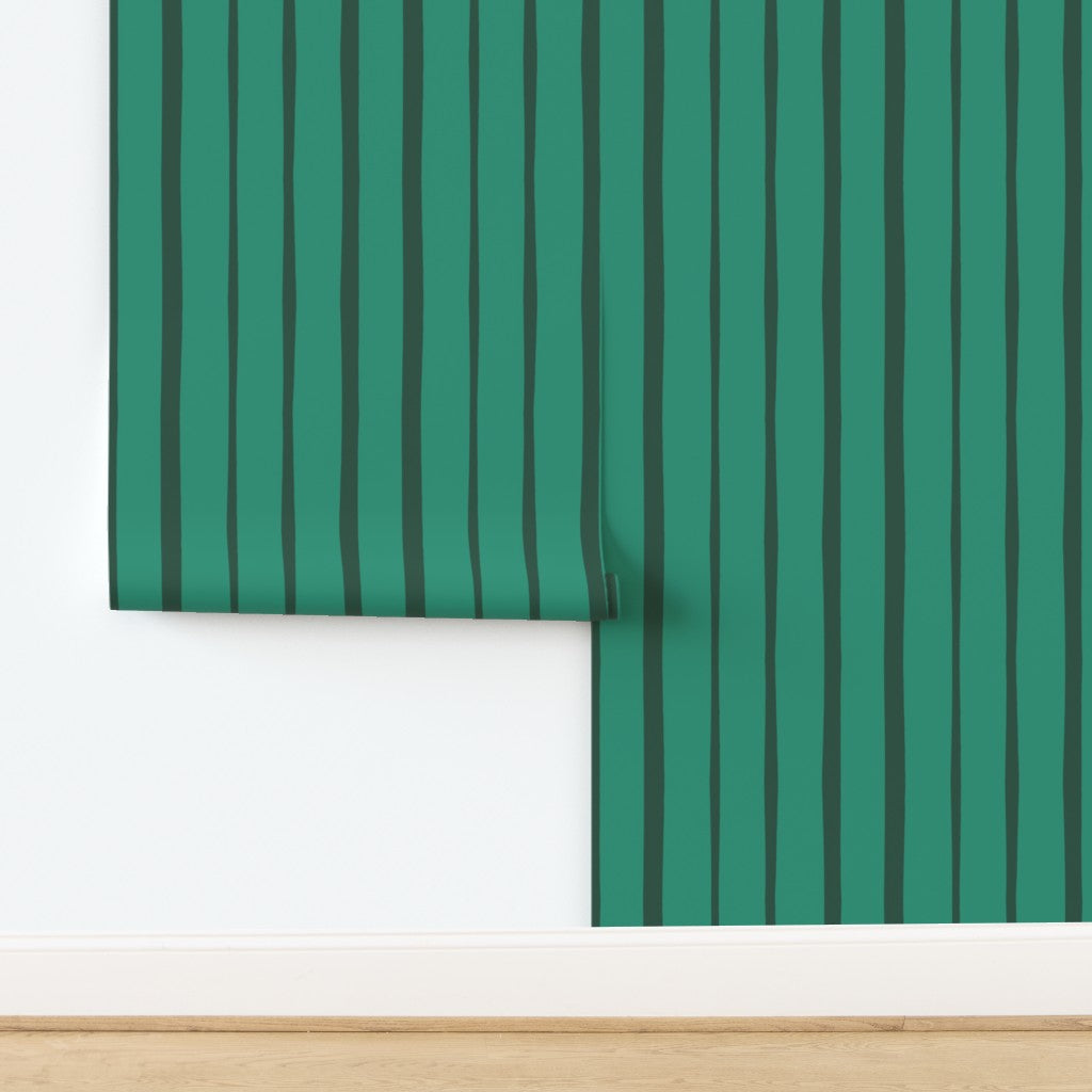 Roll of green striped wallpaper on a white background. Designed by artist Leila Simon Hayes.