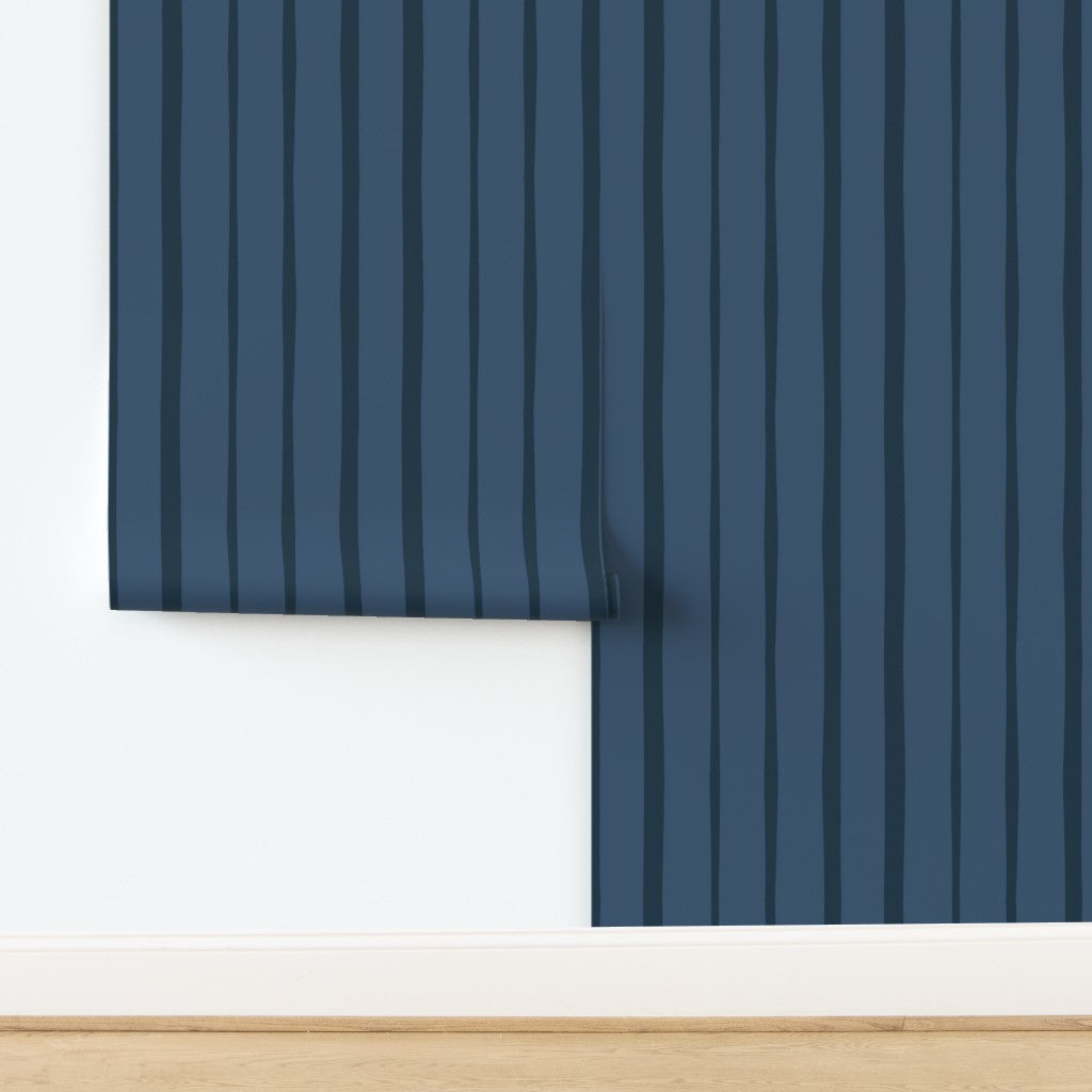 Roll of blue striped wallpaper on a white background. Designed by artist Leila Simon Hayes.