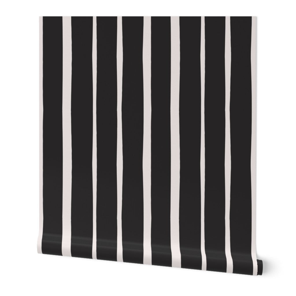 Roll of black and white striped wallpaper on a white background. Designed by artist Leila Simon Hayes.