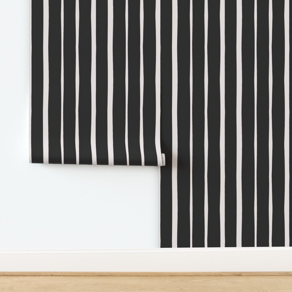 Roll of black and white striped wallpaper on a white background. Designed by artist Leila Simon Hayes.