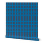 Roll of bright blue striped wallpaper that creates a grid pattern over a dark blue-gray base. Designed by artist Leila Simon Hayes.