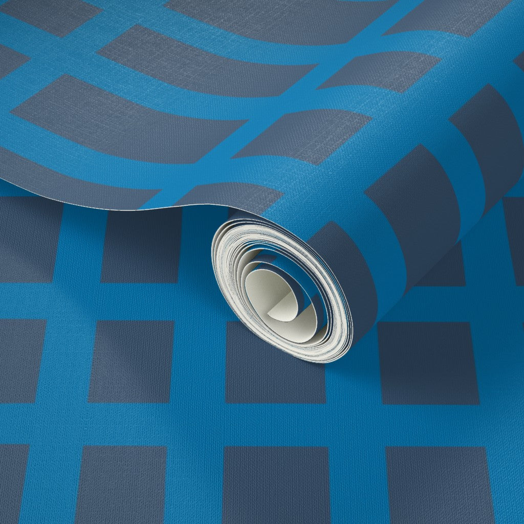 Roll of blue wallpaper with grid geometric pattern. Designed by artist Leila Simon Hayes.