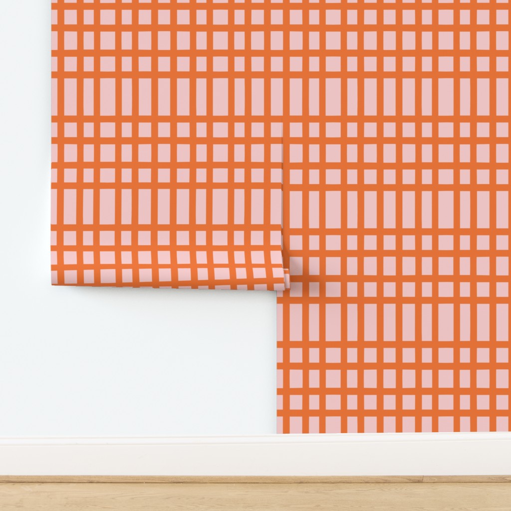Orange and pink checkered fabric on a white background. Designed by artist Leila Simon Hayes.