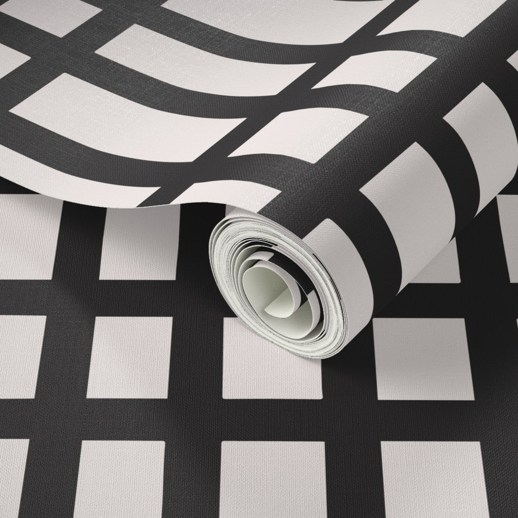 Roll of black and white patterned wallpaper on a matching background. Designed by artist Leila Simon Hayes. 