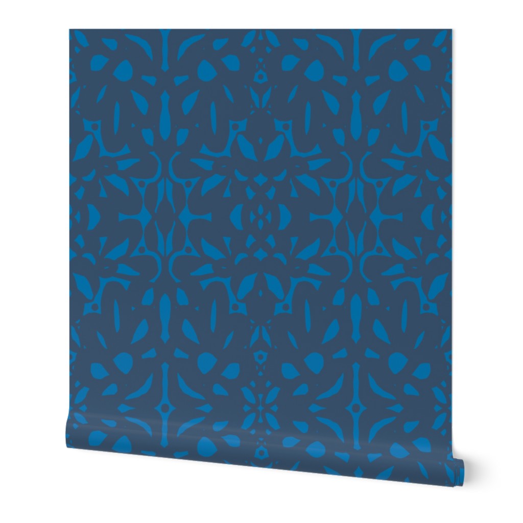 A roll of abstract wallpaper featuring a geometric pattern with dark blue shapes on a bright blue background. Designed by artist Leila Simon Hayes.