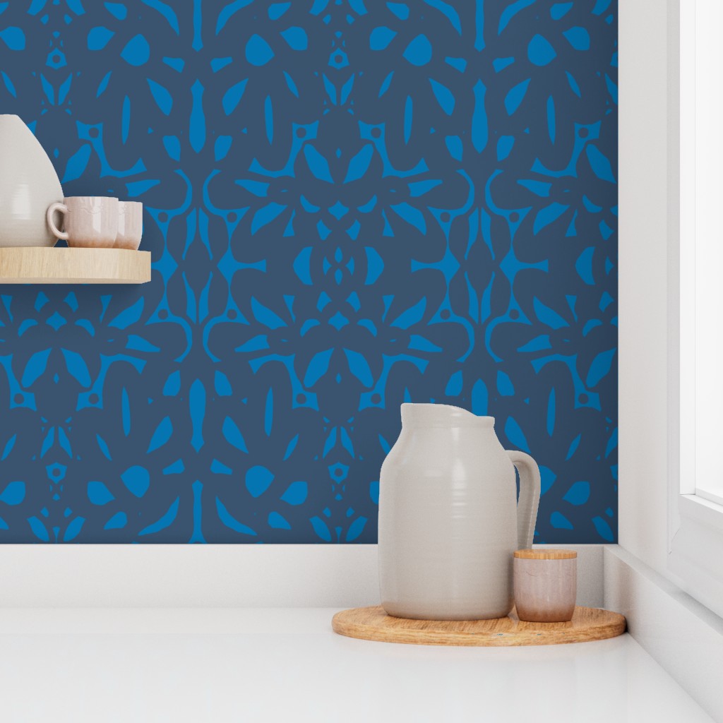 White ceramic pitcher and cups on a wooden tray against a blue patterned wall. Designed by artist Leila Simon Hayes.