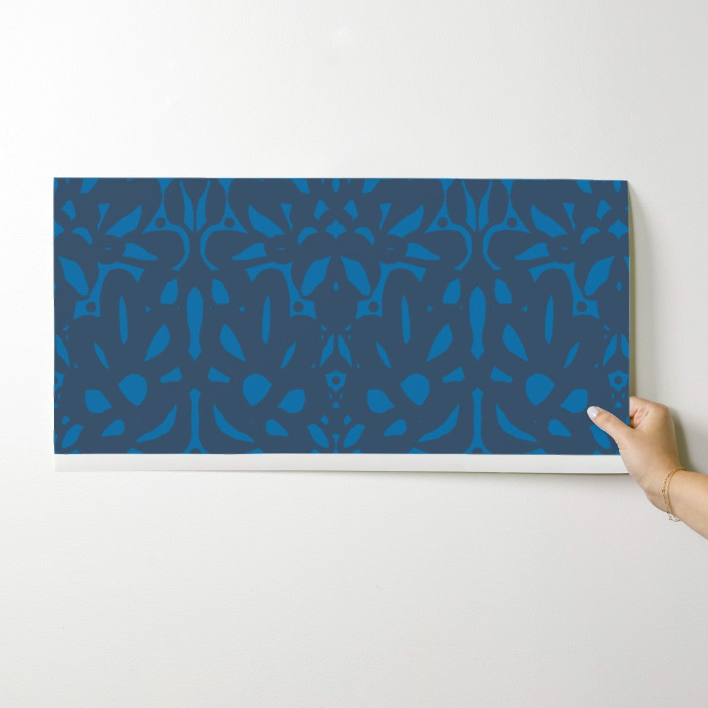 Hand holding a blue patterned wallpaper swatch object against a white background. Designed by artist Leila Simon Hayes.