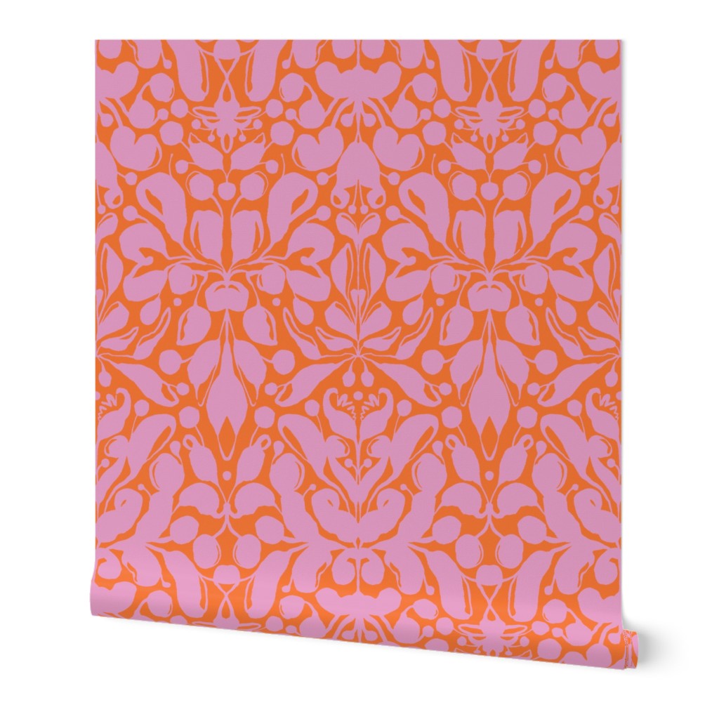 Roll of peel-and-stick wallpaper on a white background. The wallpaper is a light pink kaleidoscope, botanical, and floral pattern on an orange base. Designed by artist Leila Simon Hayes.