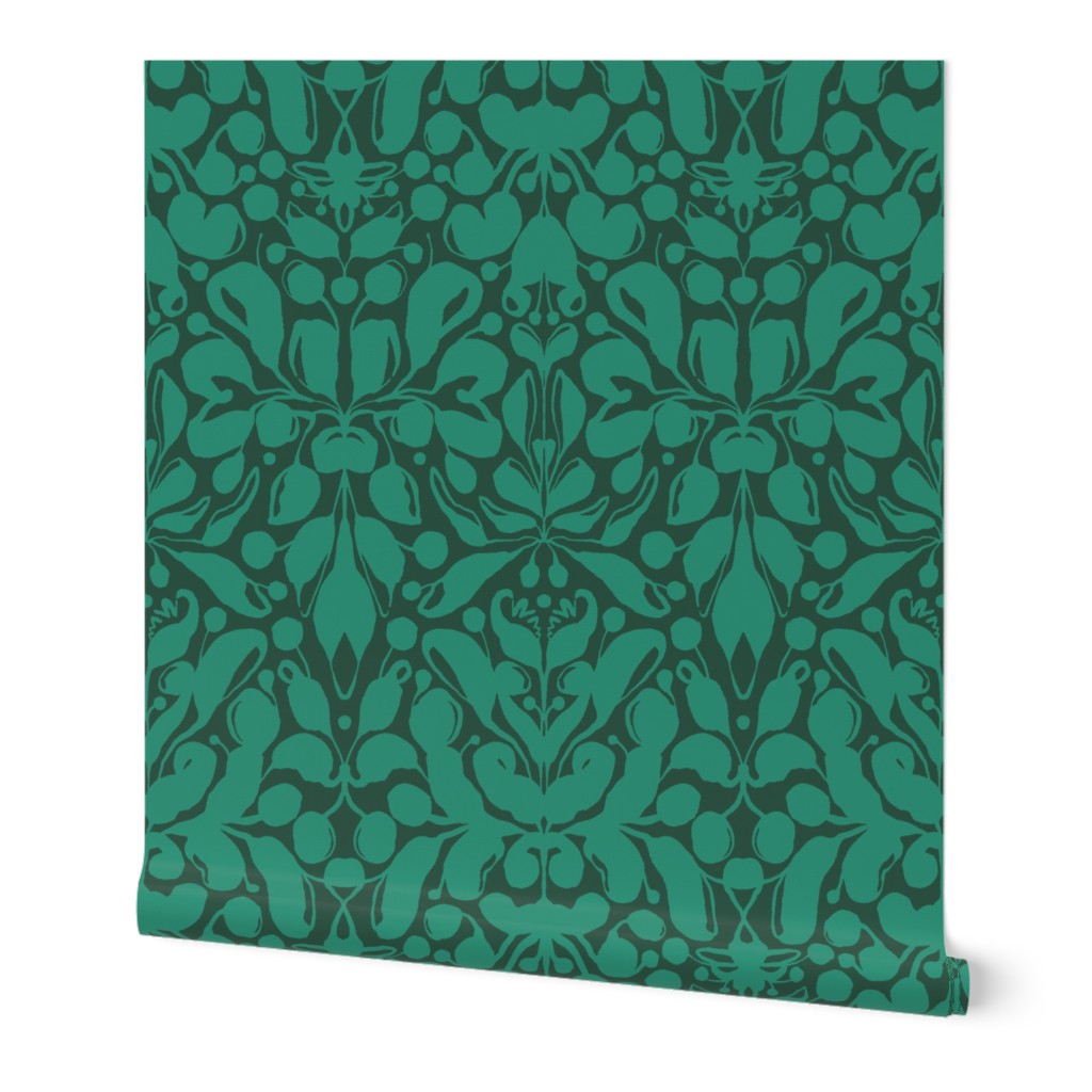 Roll of peel-and-stick wallpaper on a white background. The wallpaper is a light green kaleidoscope, botanical, and floral pattern on a dark green base. Designed by artist Leila Simon Hayes.