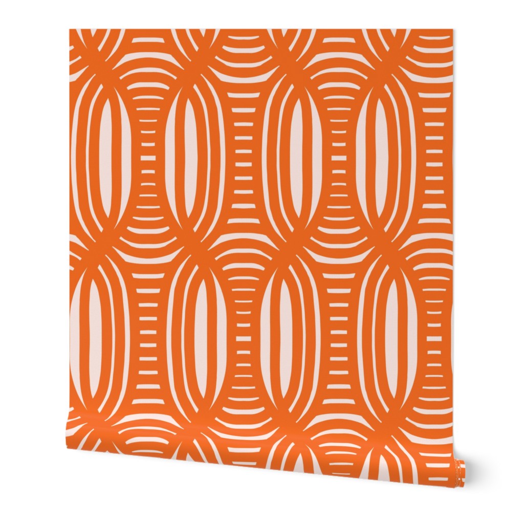 Roll of peel-and-stick geometrical wallpaper on a white background. The wallpaper has a dark orange, wavy and intersecting, weave pattern over light peach base. Designed by artist Leila Simon Hayes.