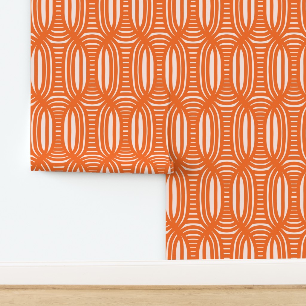 Coral geometric patterned wallpaper on a white wall with wooden baseboard. Designed by artist Leila Simon Hayes.