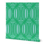 Roll of peel-and-stick geometrical wallpaper on a white background. The wallpaper has a bright green, wavy and intersecting, weave pattern over a light blue base. Designed by artist Leila Simon Hayes.
