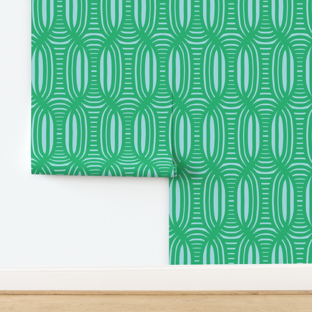 Green patterned wallpaper on a white wall with a wooden baseboard. Designed by artist Leila Simon Hayes.