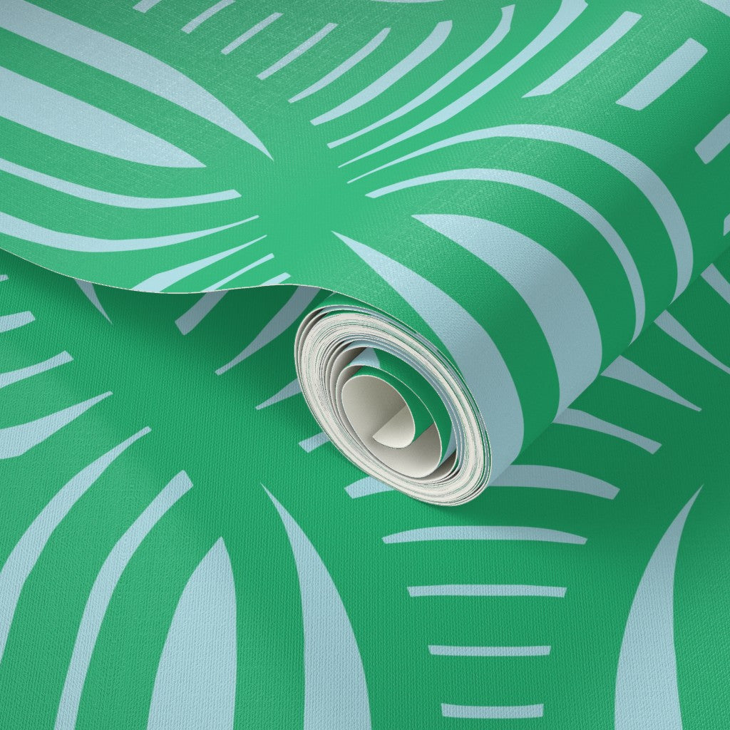 Roll of green wallpaper with white abstract patterns. Designed by artist Leila Simon Hayes.