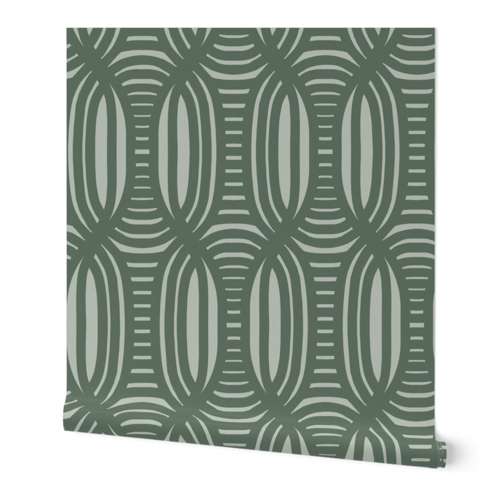 Roll of peel-and-stick wallpaper on a white background. The wallpaper is olive green, wavy and intersecting, weave pattern over a light sage green. Designed by artist Leila Simon Hayes.