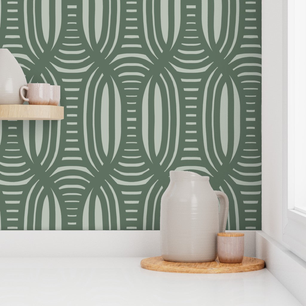 Green geometric patterned wallpaper with ceramic pitcher and cups on a shelf. Designed by artist Leila Simon Hayes.