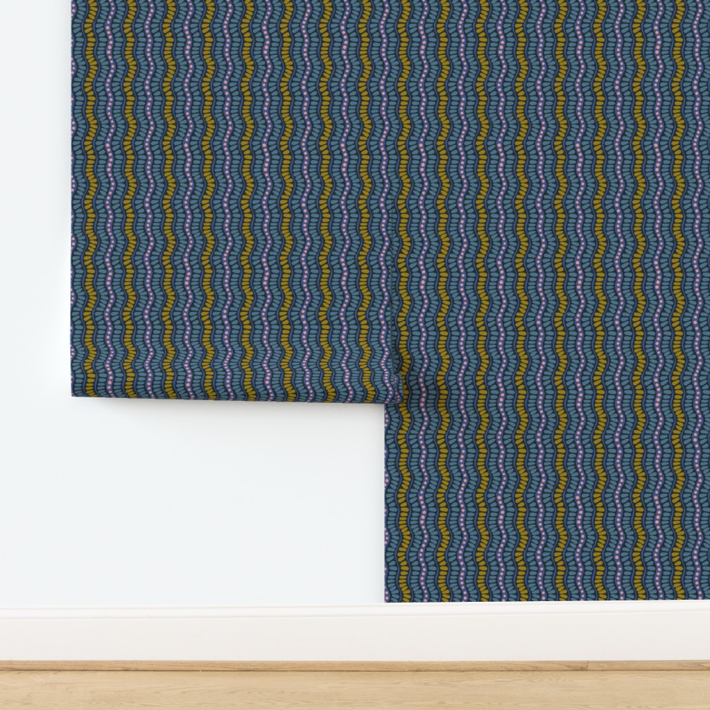 Roll of wallpaper with blue and green wavy pattern on a white background. Designed by artist Leila Simon Hayes. 