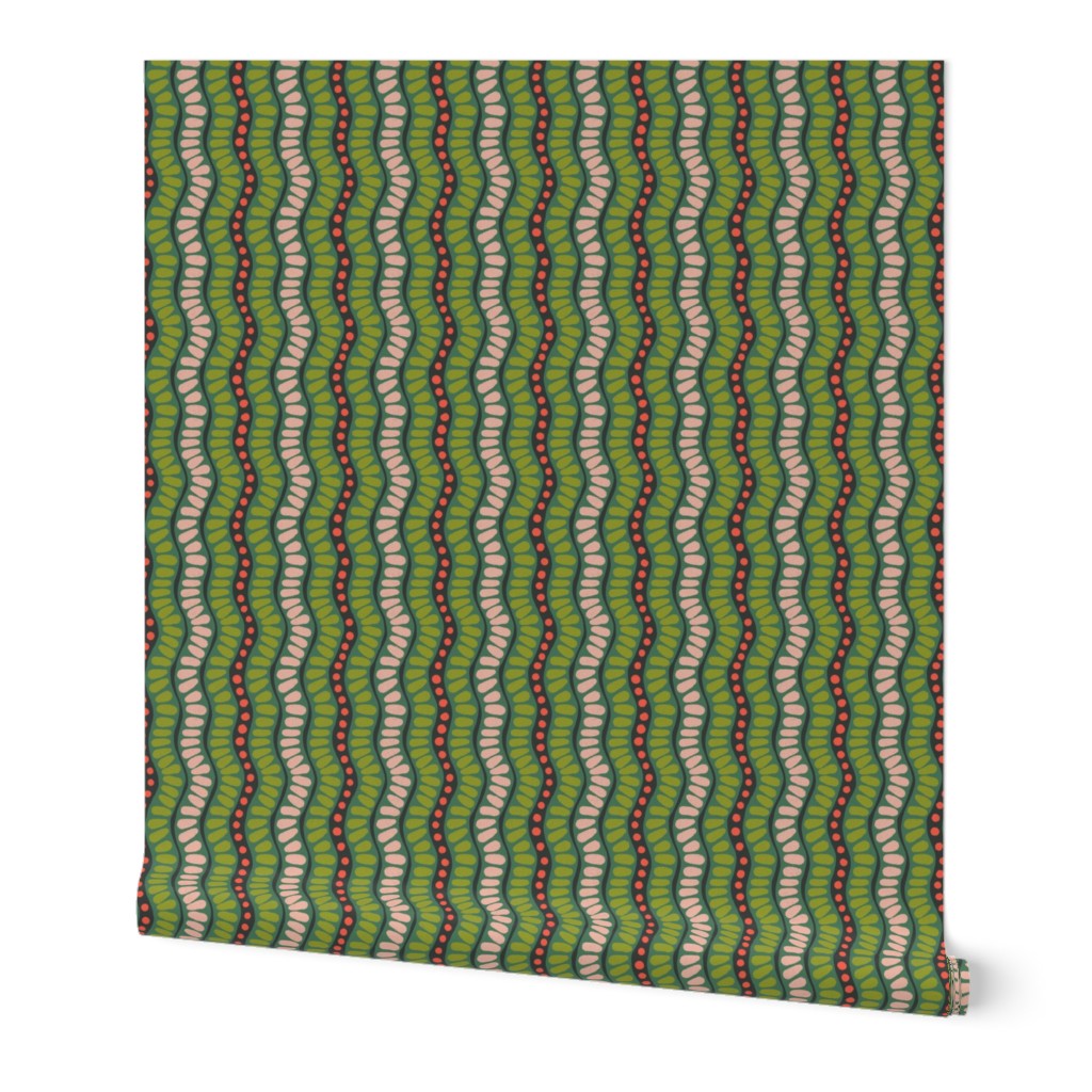 Roll of wallpaper with a green and red wavy pattern on a white background. Designed by artist Leila Simon Hayes. 