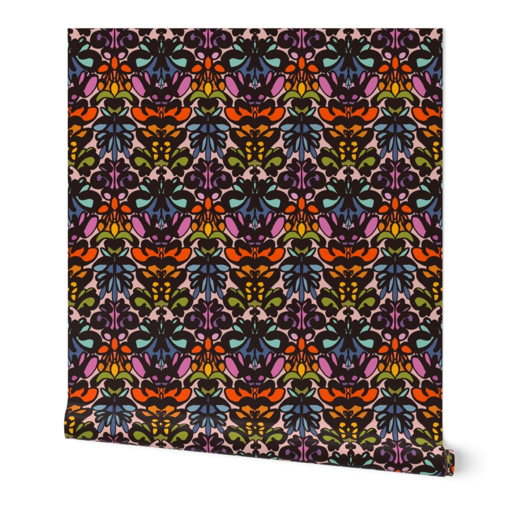Roll of peel-and-stick wallpaper on a white background. The wallpaper is a rainbow kaleidoscope pattern with black mixed in throughout. Designed by artist Leila Simon Hayes. 