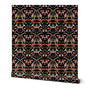 Roll of peel-and-stick wallpaper on a white background. The wallpaper is a colorful kaleidoscope pattern on a black base. Designed by artist Leila Simon Hayes. 