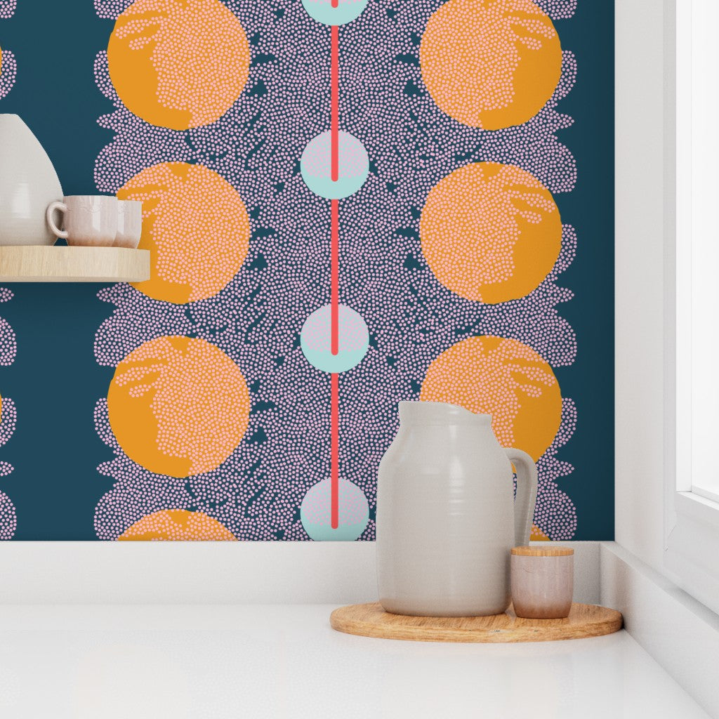 Kitchen scene with a pitcher on a wooden tray against a wall with colorful circular pattern. Designed by artist Leila Simon Hayes.