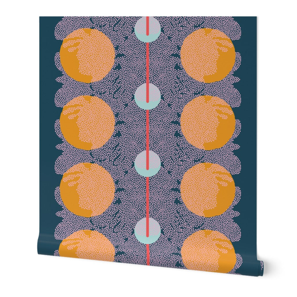 A roll of peel-and-stick wallpaper unraveled. The abstract wallpaper design has orange circular patterns and a central red line on a dark blue background. Designed by artist Leila Simon Hayes.