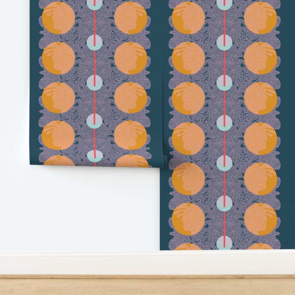 Patterned wallpaper with orange circles and blue dots on a dark blue background. Designed by artist Leila Simon Hayes.