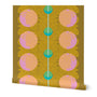 Roll of wallpaper with an abstract pattern of pink and blue circles and yellow dots on a dark yellow background, with a blue line down the middle. Designed by artist Leila Simon Hayes.