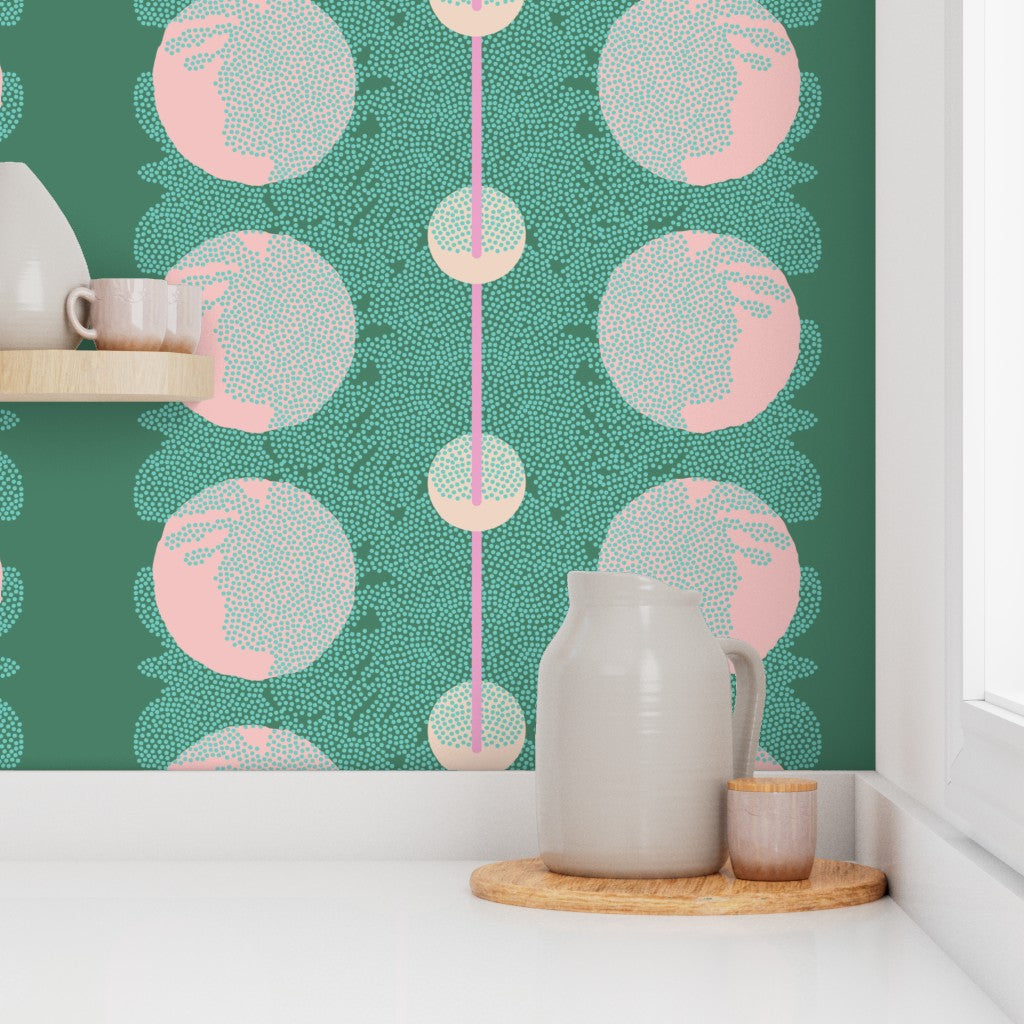 Kitchen scene with a pitcher and cups on a shelf against a green wallpaper with pink and gray circular patterns. Designed by artist Leila Simon Hayes.