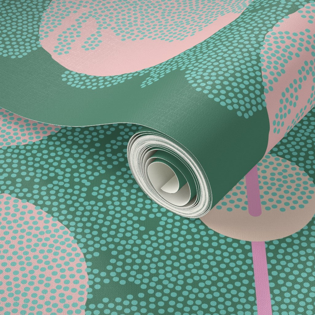 Roll of green and pink patterned wallpaper. Designed by artist Leila Simon Hayes.