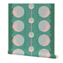 Roll of wallpaper with an abstract pattern of pink circles and neon blue dots overlapping and a pink stripe down the middle, on a green base. Designed by artist Leila Simon Hayes.