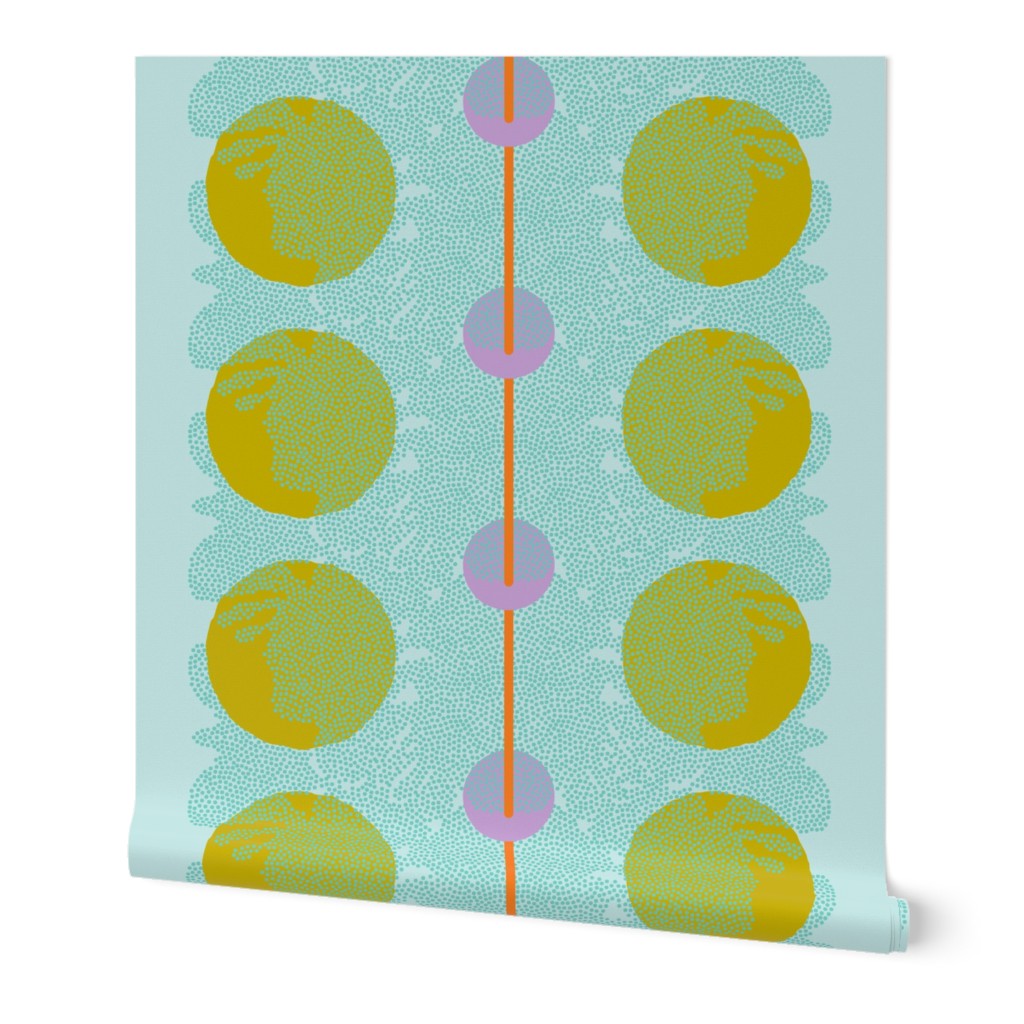 A roll of peel-and-stick wallpaper unraveled, on a white background. The abstract wallpaper design has yellow and pink circles, blue dots, and a red stripe down the middle, on a light blue base. Designed by artist Leila Simon Hayes.