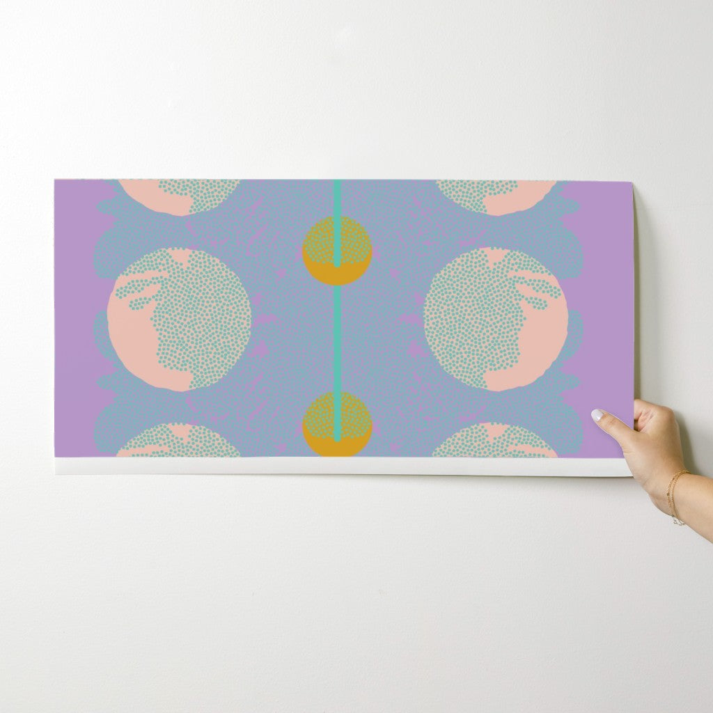 Wallpaper swatch with abstract pattern held by a hand on a white background. Designed by artist Leila Simon Hayes.