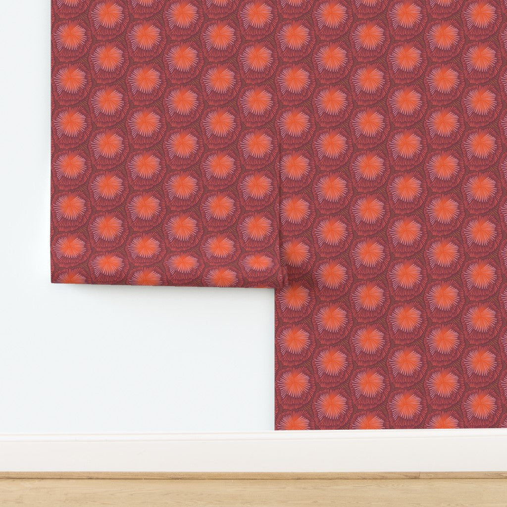 Patterned paper with red and orange design on a white background. Designed by artist Leila Simon Hayes.